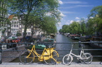 Bicycles leaning against the railings of a bridge over the Keizersgracht canal