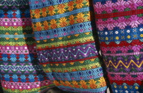 Close view of contrasting  multi coloured pattern textiles. Colored