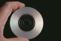 Hand holding a CD single showing the recorded sideAudio