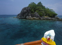 Tourists snorkling over coral reefs near Giant Island  Koh Yang  with bow of boat in foreground.