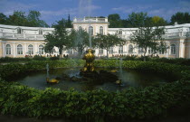 Peterhof Palace grounds.  The Orangerie in the lower gardens with circular pond and fountain in the foreground.