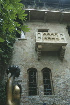 Casa di Giulietta  Juliets balcony at Number Twenty Seven Via Cappello.  Statue of Juliet in the foreground below.