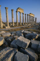 Historical site of Roman military headquarters above the village of Qalaat Mudiq.  Colonnaded street with fallen masonry in the immediate foreground.