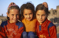 Three smiling young girls.