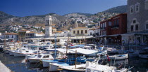 Hydra Town.  Harbour with moored boats and town on hillside behind.