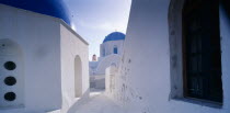 Part view of white painted church with blue  domed roof.