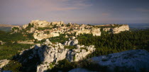 View over rocky outcrop towards fortified hill town.  Bouches du Rhone.