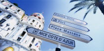 Promenade des Anglais.  Angled view of directional road sign in front of the Hotel Negresco  partly seen behind.  Alpes Maritimes