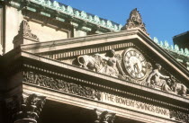 The Bowery Savings Bank Building.  Detail of ornate masonry on roof with clock and the bank s name carved below.