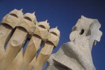 La Pedrera apartments designed by Gaudi with angled view of chimney pots.