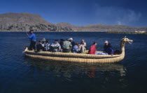 Lake Titicaca.  Tourists on a reed boat on the lake.