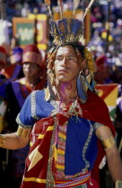 Male figure in traditional costume and feathered headress at Inti Raymi.  Threequarter shot.