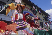 Women in traditional costume on a processional float during Inti Raymi.
