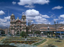 Plaza de Armas.  View across colourful  formal garden towards La Compaa de Jess.