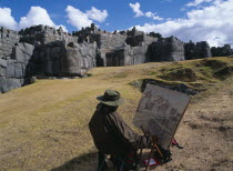 Artist at his easel infront of the Inca walls in ruined ceremonial centre.
