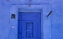 Detail of blue painted house and entrance with a starfish above a doorway in this Red Sea coastal town