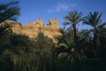 Temple Of The Oracle on hilltop above date palm filled oasis