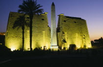 The Temple Pylons with Obelisk and statues of Ramesses II illuminated at night