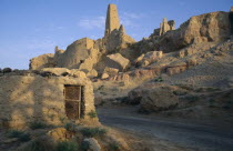 Temple Of The Oracle 1 ruins on hillside above a road