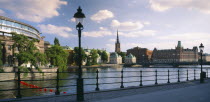 View from path across water towards waterfront buildings.