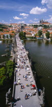 Mala Strana.  Charles Bridge.  Aerial view along bridge busy  with tourists and traders selling souvenirs.