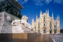 The Duomo with stone statue of lion on plinth in the foreground.