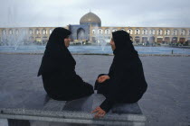 Emam Khomeini SquareTwo women talking Sheikh Lot Fallah mosque in background Isfahan