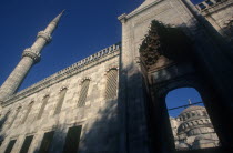 Blue Mosque or Sultan Ahmet Cami mosque. Angled view looking up toward archway and tower