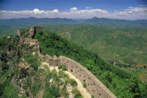 Thin section of  the Great wall near Beijing disappearing into the distant hills