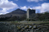 Moy Castle on the shores of Loch Bui  mountain peak behind.