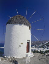 Thatched and whitewashed harbour windmill now a folk museum above the town