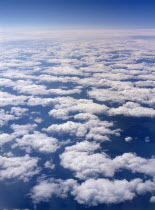 Aerial view above sparse clouds from plane flying over Siberia