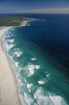 View along Noordhoek Beach with waves rolling into the empty beach