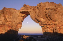 The Wolfberg Arch rock formation framing the rising moon.