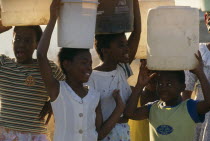 Young girls carrying water on their heads drawn from the Umgeni Water community water tap  Hopewell.