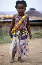 Young Zulu Girl dressed up by her sisters in traditional clothes