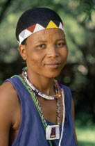 Zulu woman wearing head band and necklace of beads that denotes her change of status to womanhood