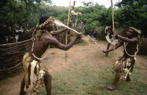 Zulu men demonstrating traditional fighting with sticks