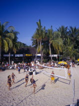 Siloso Beach  volley ball game on sandy beach  palms