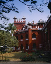 Curzon Hall.  Red and white exterior facade and gardens.