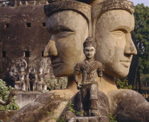 Wat Xieng Khwan or the Buddha Park.  Giant twin heads with small statue in the foreground.