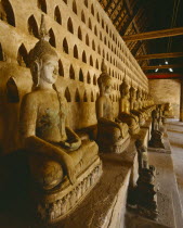 Wat Si Saket  the oldest city temple.  Interior with row of seated Buddha figures.