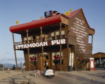 Ettamogah Pub an unusual timber building with a red roof and odd signs