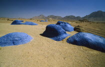 Blue rocks on floor of semi desert valley