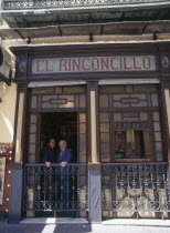 Macarena District El Rinconcillo where Tapas originated with two men standing at a window