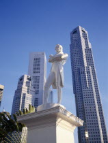 Statue of Sir Stamford Raffles with high rise buildings in Raffles Place behind.
