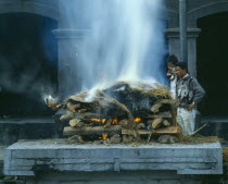 Cremation ceremony.  Funeral pyre and burning body.