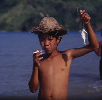 Boy smoking cigarette  hat  small fish on line