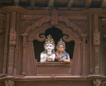 Durbar Square.  Coloured carvings of Shiva and Parvati.