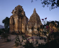 Po Nagar Cham  two ornate stone towers framed by tree branches